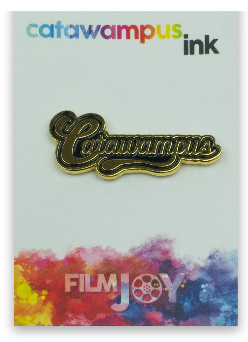 The Catawampus enamel pin on a backing card.